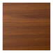 A close-up of a light walnut woodgrain table top.