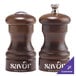 A close-up of a Chef Specialties walnut pepper mill and salt shaker with white text.