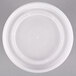A white plastic bowl with a clear lid on top.