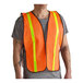 An orange high visibility mesh safety vest with 1-inch reflective tape worn over a gray t-shirt.