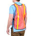 A man wearing a Cordova orange high visibility safety vest with reflective tape.