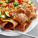 A plate with Upton's Naturals vegan seitan strips, rice, and a fork.