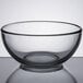 A Libbey clear glass bowl on a reflective surface.