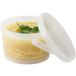 A clear plastic lid on a container of soup.