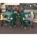 A green Cambro food cart on heavy-duty casters holding food with two women nearby.