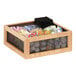 A Cal-Mil oak wood condiment organizer with a black metal mesh bag inside.