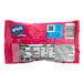 A pink Nerds Gummy Clusters pouch with white and black text.