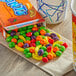 A box of Runts candy on a table with a cup of coffee.