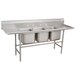 A stainless steel Advance Tabco three compartment pot sink with two drainboards.