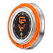 A Holland Bar Stool San Francisco Giants neon clock on a counter with orange rims.