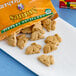 A bag of Annie's Organic Honey Bunny Grahams on a counter next to a bag of carrots.