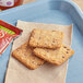 Nature Valley Crisps Chocolate Chip snack bars on a table with a package of food.