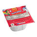 A white container of Lucky Charms cereal with a red wrapper featuring a cartoon leprechaun and a unicorn.