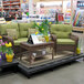 A Benchmaster platform display with a table and chairs in a furniture store.