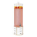 A white and pink Cal-Mil beverage dispenser with fruit inside.