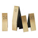 A set of Cal-Mil gold and black rectangular metal table number tents with numbers on them.