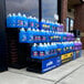 A Benchmaster black heavy-duty plastic three step display holding blue bottles of car wash cleaner.