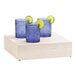 A Cal-Mil white-washed pine wood display riser holding three blue glasses with lime slices on top.