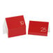 A stack of red Cal-Mil table tents with white numbers.