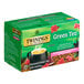 A green box of Twinings Green Tea, Pomegranate, Raspberry, & Strawberry Tea Bags with a white background.