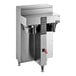 A silver stainless steel Fetco CBS-1252 Plus Series Twin automatic coffee brewer on a counter with black and red buttons.