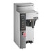 A Fetco CBS-1231 Plus commercial coffee machine with a plastic brew basket and buttons.