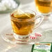 A glass of Twinings Pure Peppermint tea with a tea bag in it.