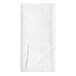 A white cloth napkin folded in half on a white surface.