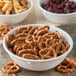 A white Carlisle Dallas Ware nappie bowl filled with pretzels.
