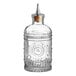A clear glass Barfly Bitters Bottle with a metal stopper.