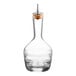 A clear glass Barfly bitters bottle with a cork stopper.
