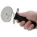 A hand holding a Tablecraft FirmGrip pizza cutter.