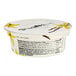 A Chobani Non-Fat Vanilla Greek Yogurt container with a yellow label with flowers.