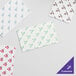 A group of white Choice customizable interfolded bakery tissue sheets.