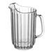 A clear plastic pitcher with a handle.