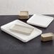 A group of American Metalcraft rectangular white melamine plates.
