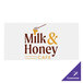 A white rectangular Carnival King vinyl sticker with brown text that says "Milk and Honey Cafe"