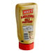 A Mike's Amazing Stoneground Deli Mustard squeeze bottle on a counter.