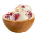 A close-up of red and white G.S. Gelato Raspberry Cheesecake gelato in a bowl.