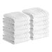 A stack of white Lavex Luxury bath mats.