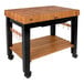 A John Boos cherry wood table with an undershelf and casters.