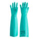 A pair of green Ansell AlphaTec Solvex rubber gloves with a sandpatch pattern on a counter.