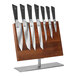 A Mercer Culinary Damascus knife set on a wooden stand.