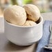 A bowl of Eclipse Foods vegan vanilla ice cream with a spoon.