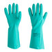 A pair of green Ansell AlphaTec rubber gloves with raised diamond grip on a white background.