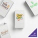 A set of customizable white paper bags featuring various business logos.
