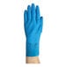 A blue natural latex rubber glove with a fish scale grip, shown worn on a hand.