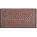 A Guittard Solitaire 54% Dark Chocolate bar on a table.