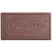 A brown rectangular Guittard chocolate bar with the word Guittard on it.