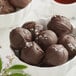 A bowl of Guittard chocolate truffles on a counter.